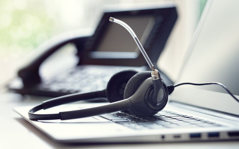 Headset headphones telephone and laptop in call center